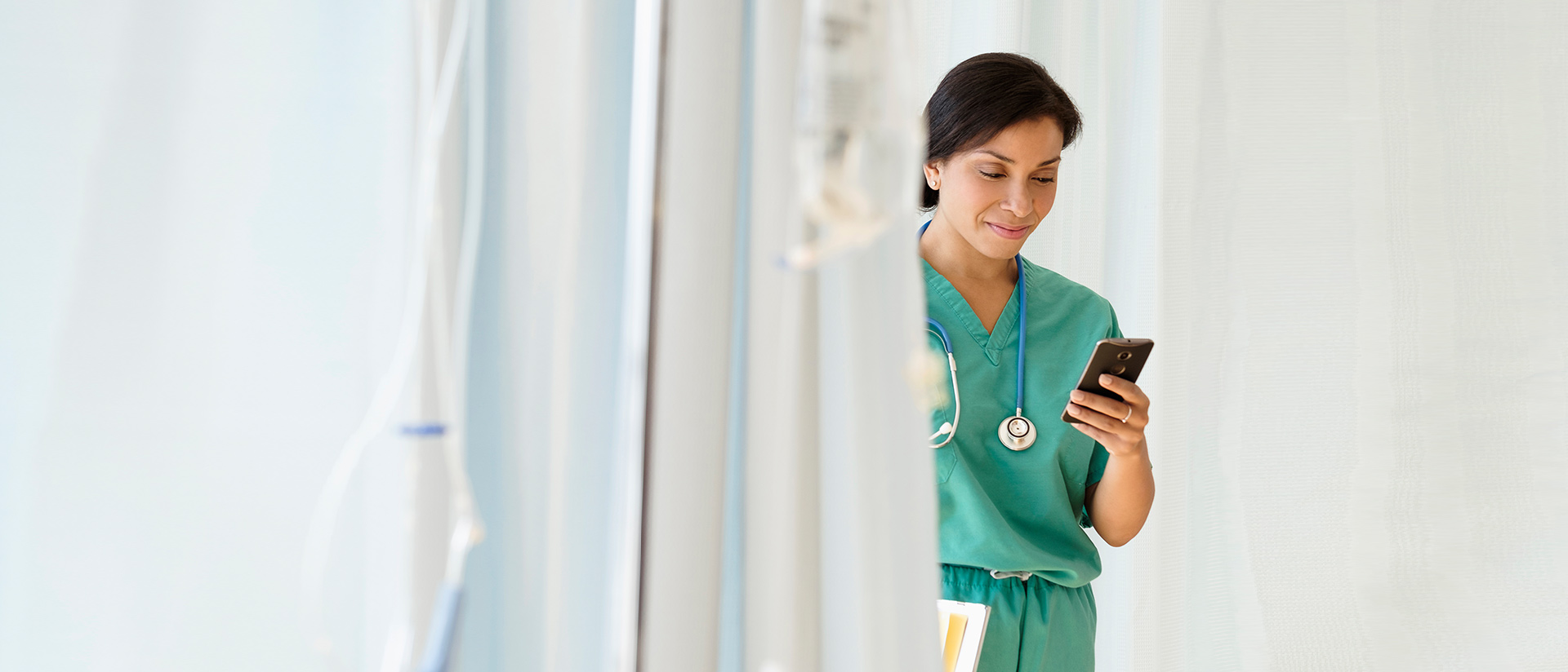 female nurse looking at cell phone