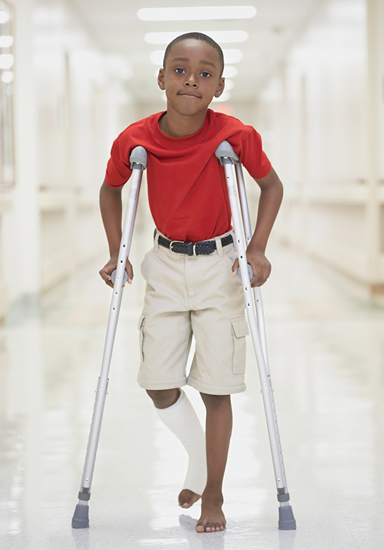 little boy with crutches 