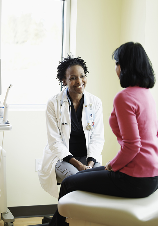 woman talking to her OBGYN